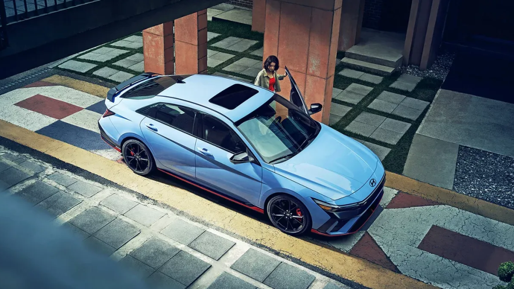 2025 ELANTRAN in performance blue parked on a street with a person opening the driver side door